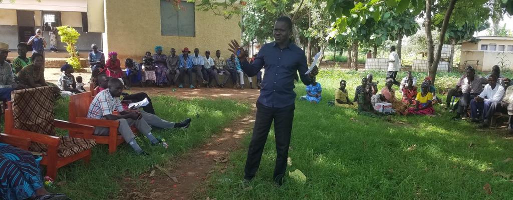 Community engagement on climate smart agriculture inputs in Lagoro Sub county Lc3 chairperson addressing the community 